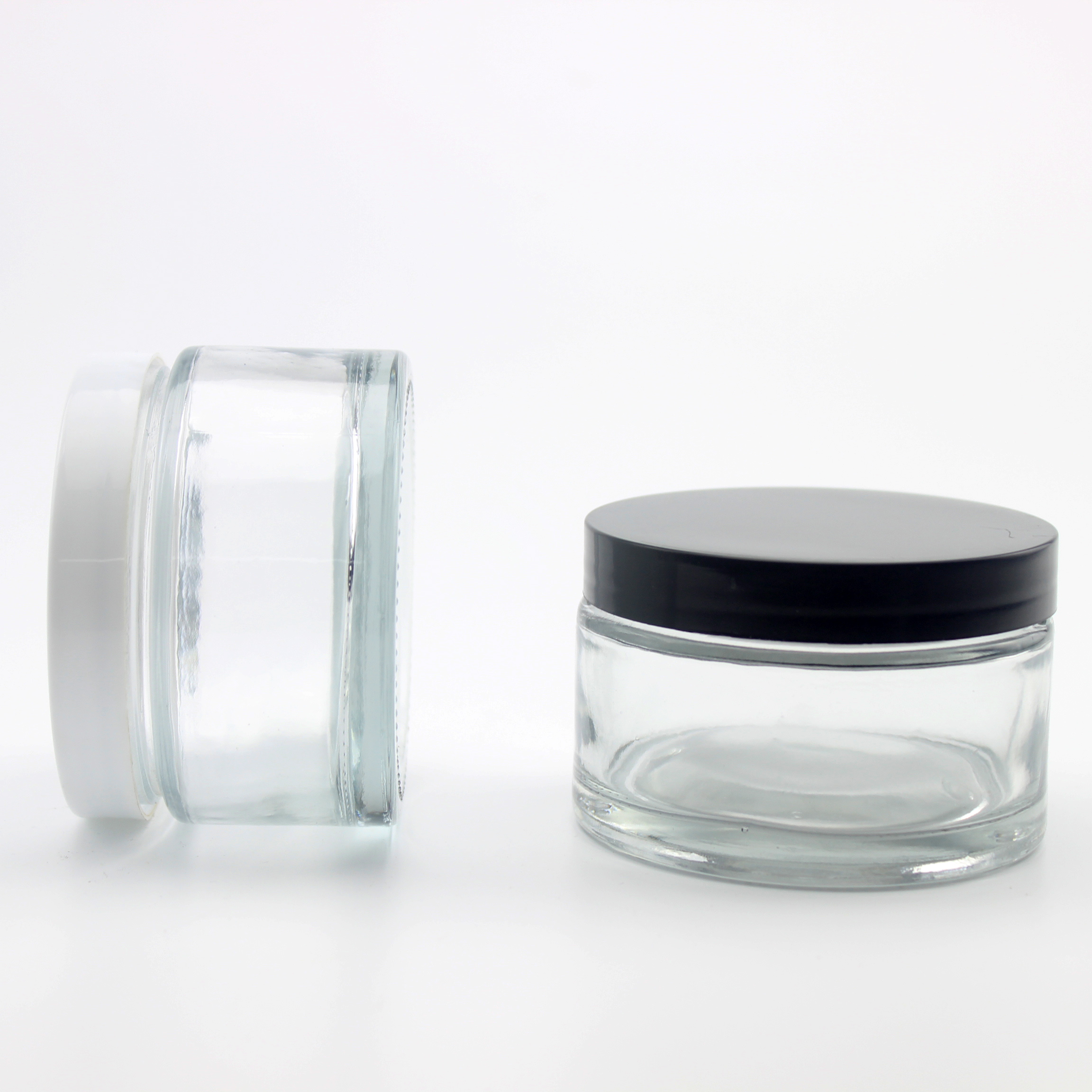 Clear round glass cream jar with liner and lid